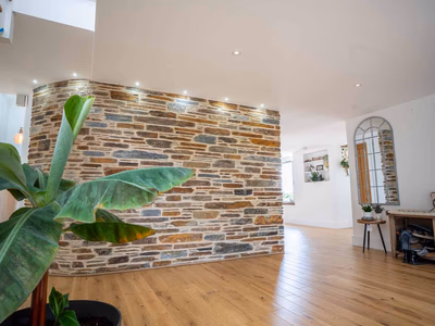 Interior curved stone feature wall with exposed masonry