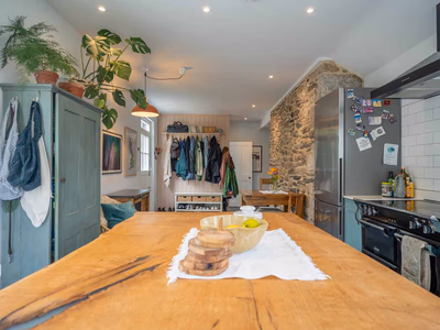 Open-plan living area with exposed stone