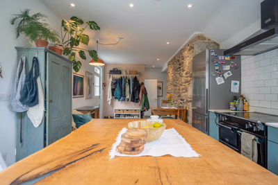 Open-plan living area with exposed stone