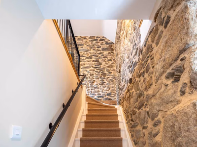 Exposed stone walls with vaulted ceiling