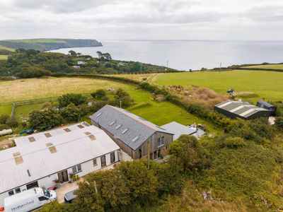Coastal property aerial view showing timber barn