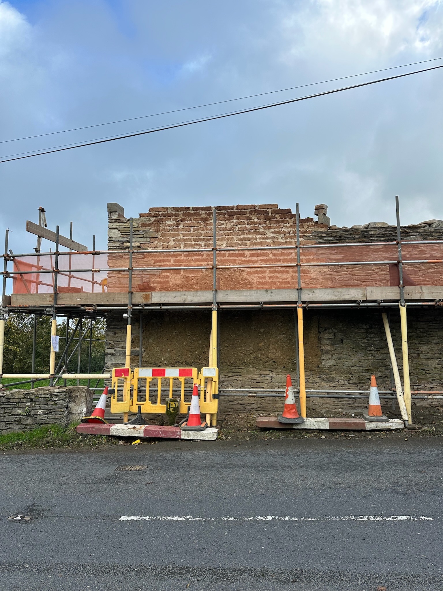 The failing roadside elevation taken down to sound fabric, ready for the rebuild