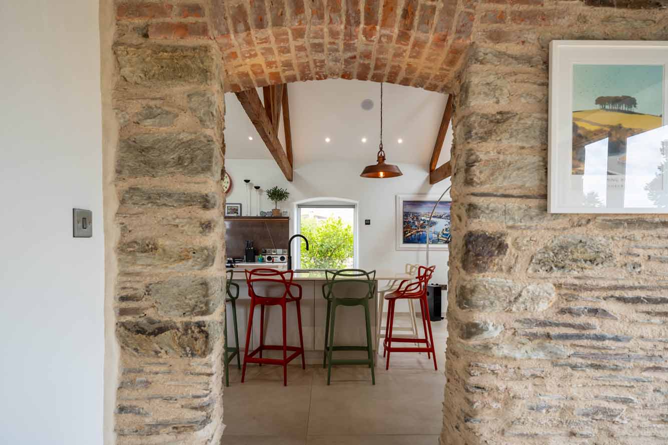 Open-plan barn conversion kitchen with stone pillars