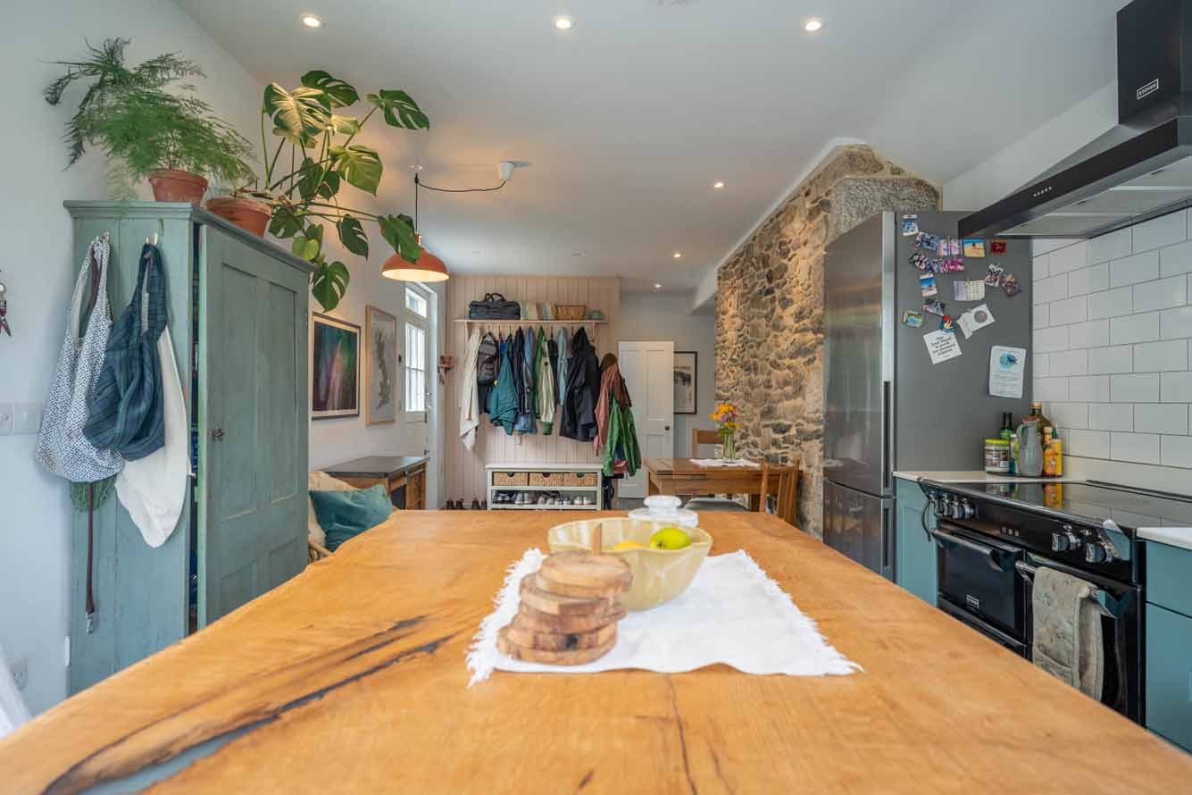 Open-plan living area with exposed stone