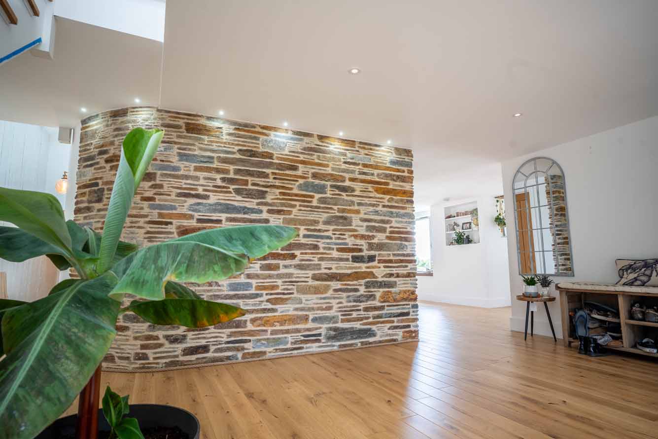 Interior curved stone feature wall with exposed masonry